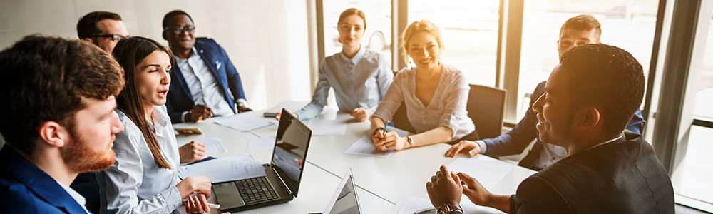 staff sitting around conference table